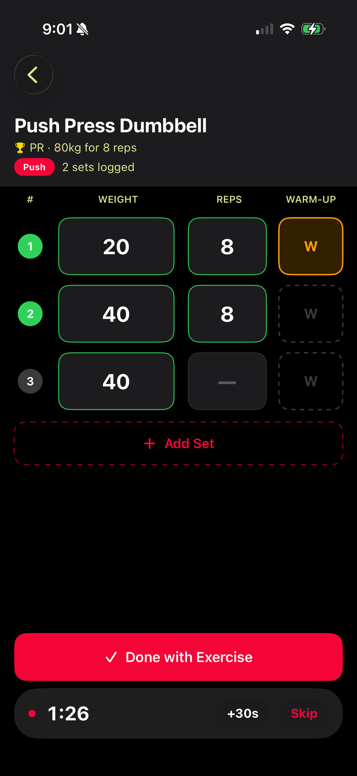 Active workout session showing Push Press Dumbbell with rest timer running and sets logged